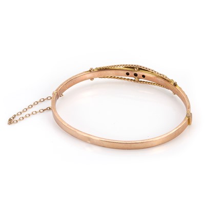 Lot 46 - A 9ct gold ruby and rose cut diamond bangle