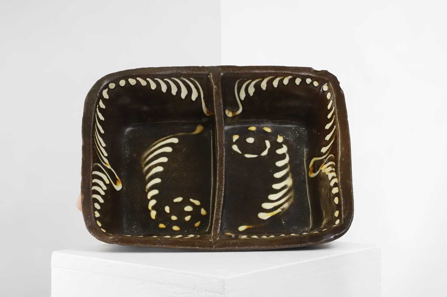 Lot 363 - A glazed earthenware slipware dish