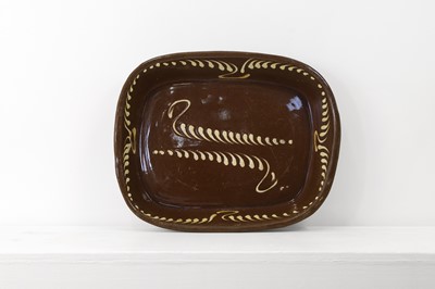 Lot 401 - A large glazed earthenware slipware dish