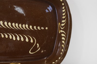 Lot 401 - A large glazed earthenware slipware dish