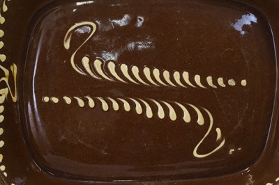 Lot 401 - A large glazed earthenware slipware dish