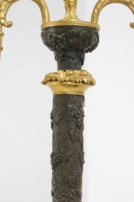 Lot A pair of George III-style patinated and gilt-bronze candelabra