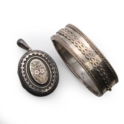 Lot 415 - A sterling silver bangle and a sterling silver Victorian oval locket