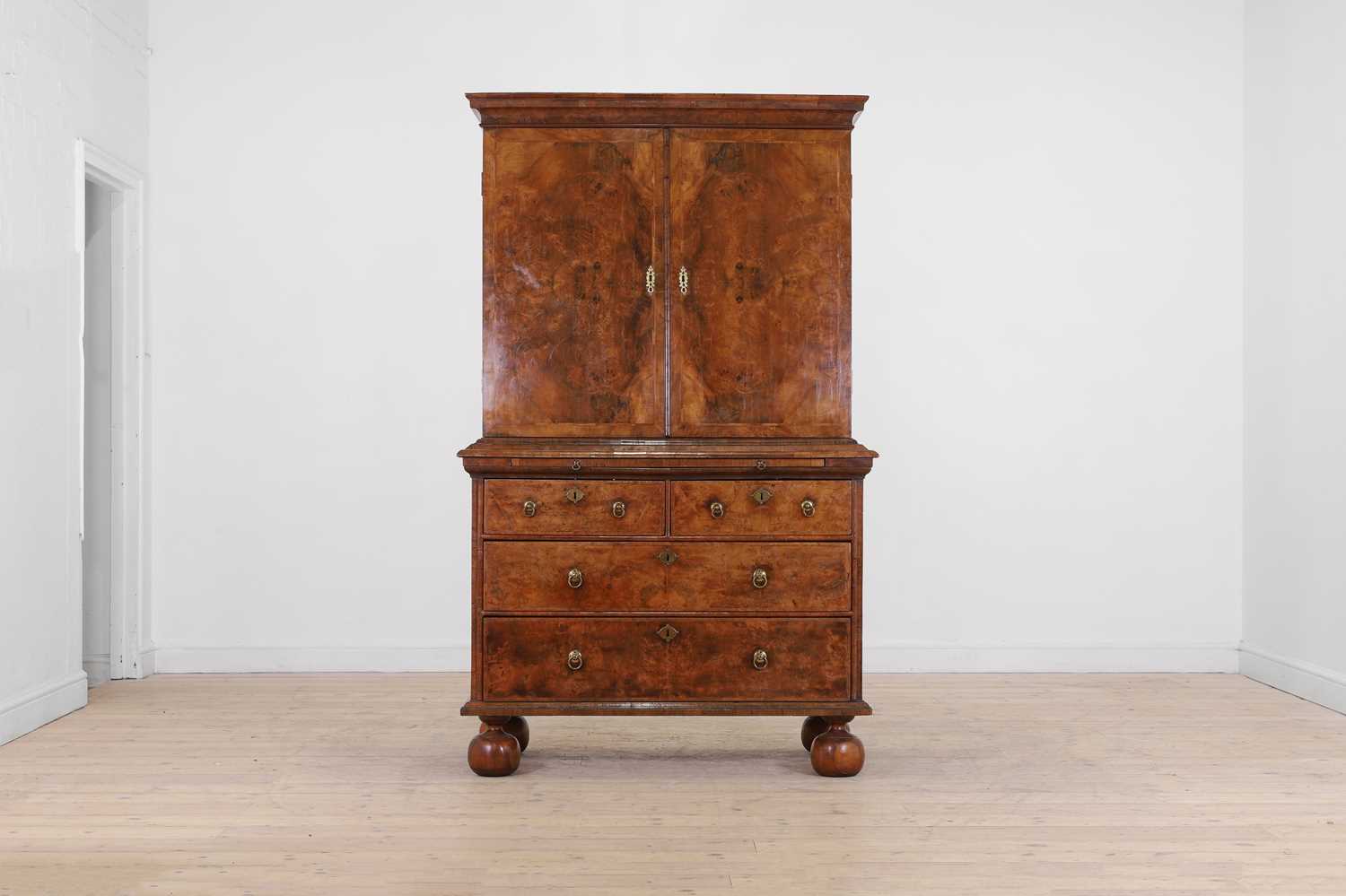 Lot 98 - A walnut cabinet on chest