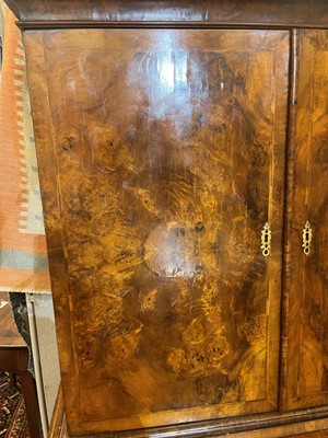 Lot 98 - A walnut cabinet on chest