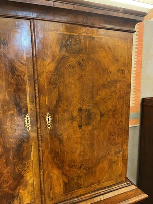 Lot 98 - A walnut cabinet on chest