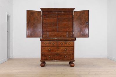 Lot 98 - A walnut cabinet on chest