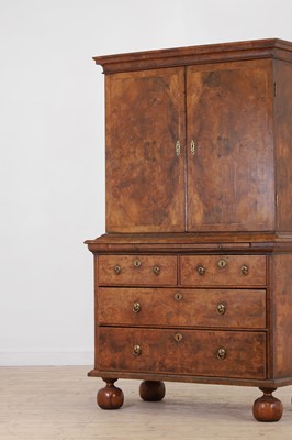 Lot 98 - A walnut cabinet on chest