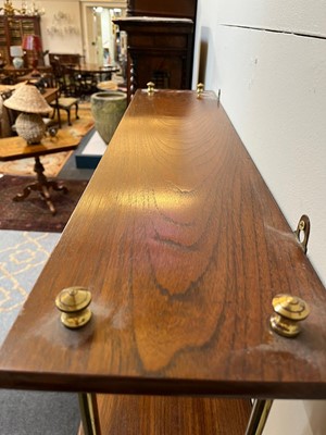 Lot 444 - A set of Regency-style mahogany and brass hanging shelves