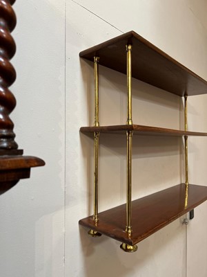 Lot 444 - A set of Regency-style mahogany and brass hanging shelves