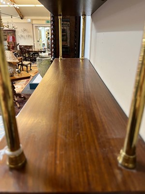 Lot 444 - A set of Regency-style mahogany and brass hanging shelves