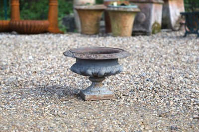 Lot 573 - A small cast iron garden urn