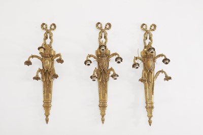 Lot 611 - A set of three Louis XVI-style brass wall lights