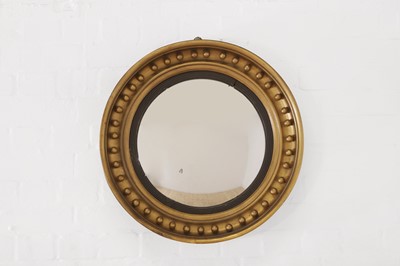 Lot 625 - A Regency-style giltwood convex mirror