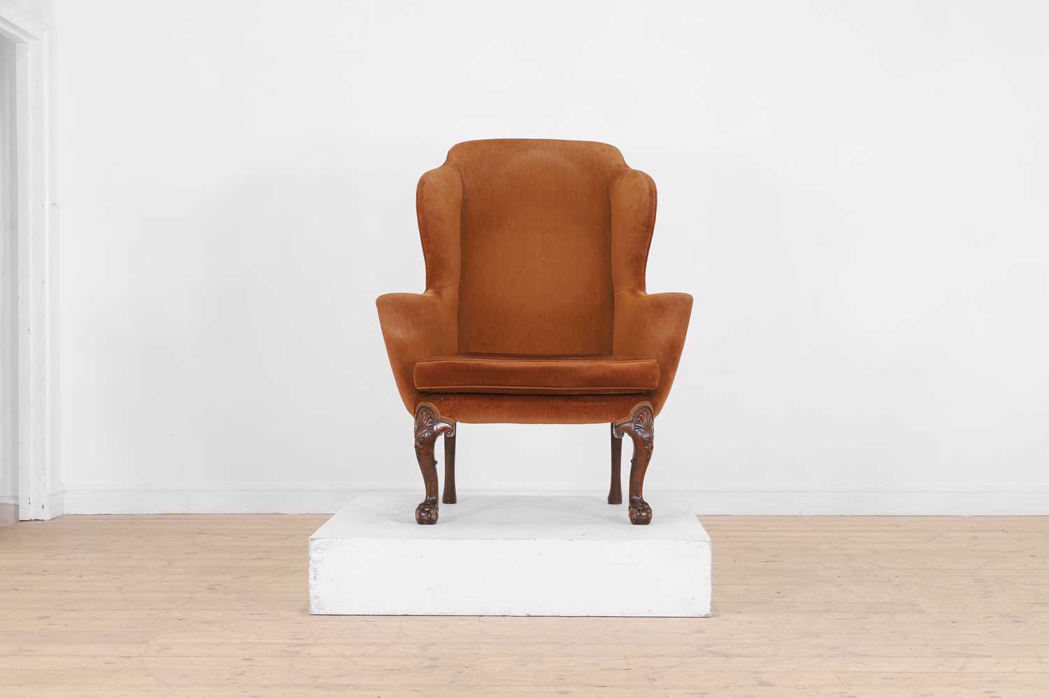 Lot 365 - A George II-style mahogany wing-back armchair