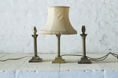 Lot 40 - A set of three brass table lamps