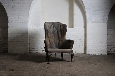 Lot 160 - A mahogany and leather wingback armchair