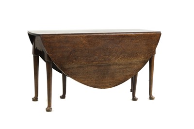 Lot 472 - A George III oak six leg drop leaf table