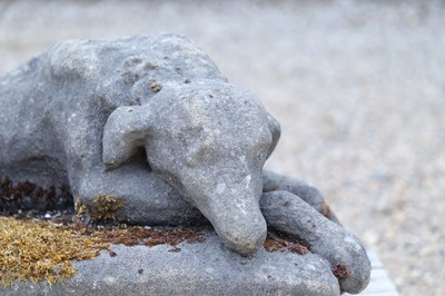 Lot 682 - A composition stone figure of a sleeping hound