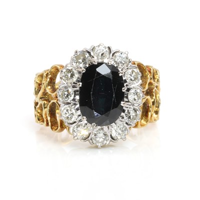 Lot 212 - A sapphire and diamond oval cluster ring, c.1970