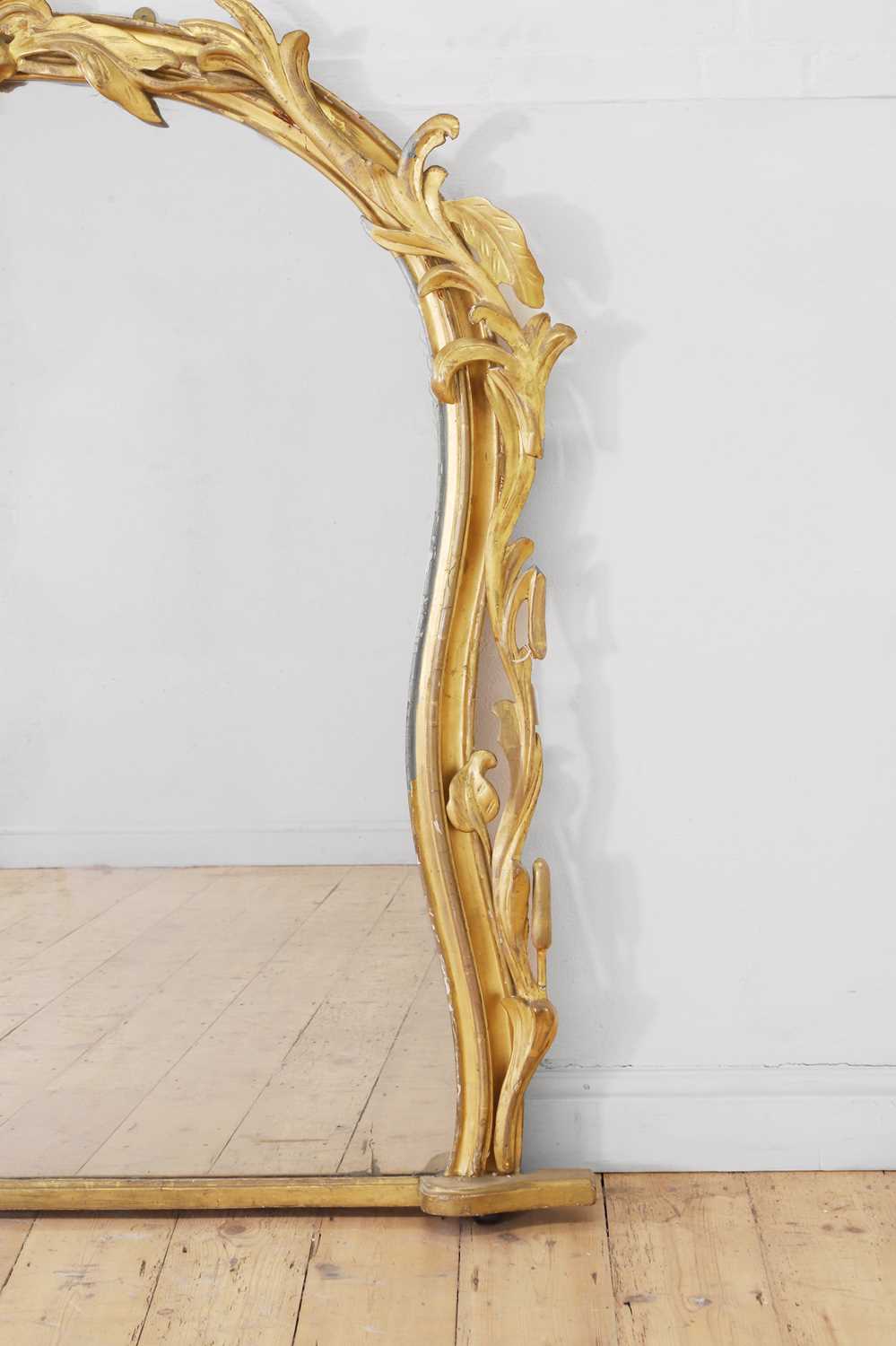 Lot 181 A carved giltwood overmantel mirror,