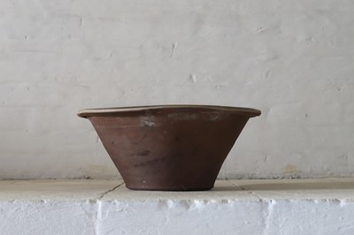 Lot 379 - A half slip-glazed terracotta dairy bowl