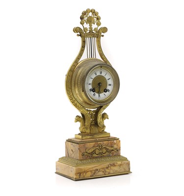 Lot 218 - A gilt metal lyre form mantel clock