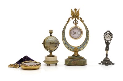 Lot 223 - A gold-plated pocket watch on stand