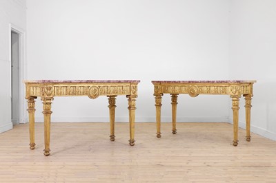 Lot A matched pair of Louis XVI giltwood console tables