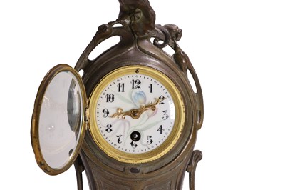 Lot 47 - A French Art Nouveau patinated bronze mantel clock