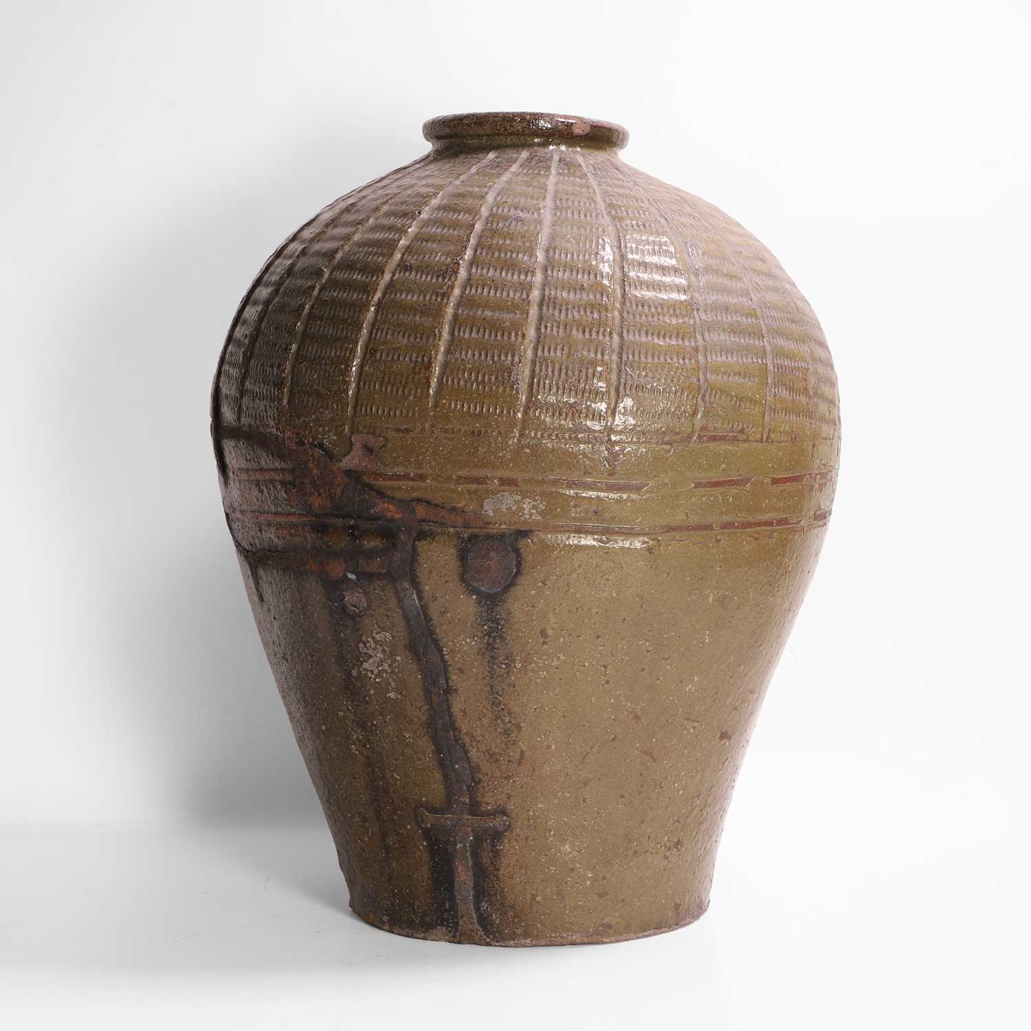 Lot 137 - A large green-glazed pottery vase