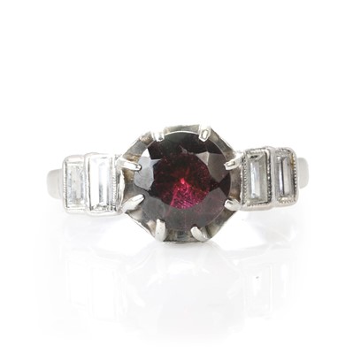 Lot 82 - A garnet and diamond platinum ring