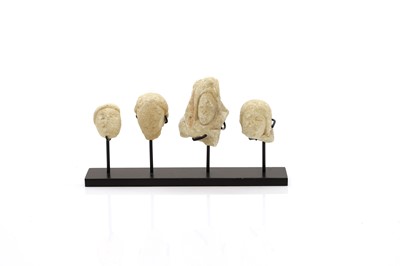 Lot 347 - A group of four Greek or Cypriot votive limestone heads