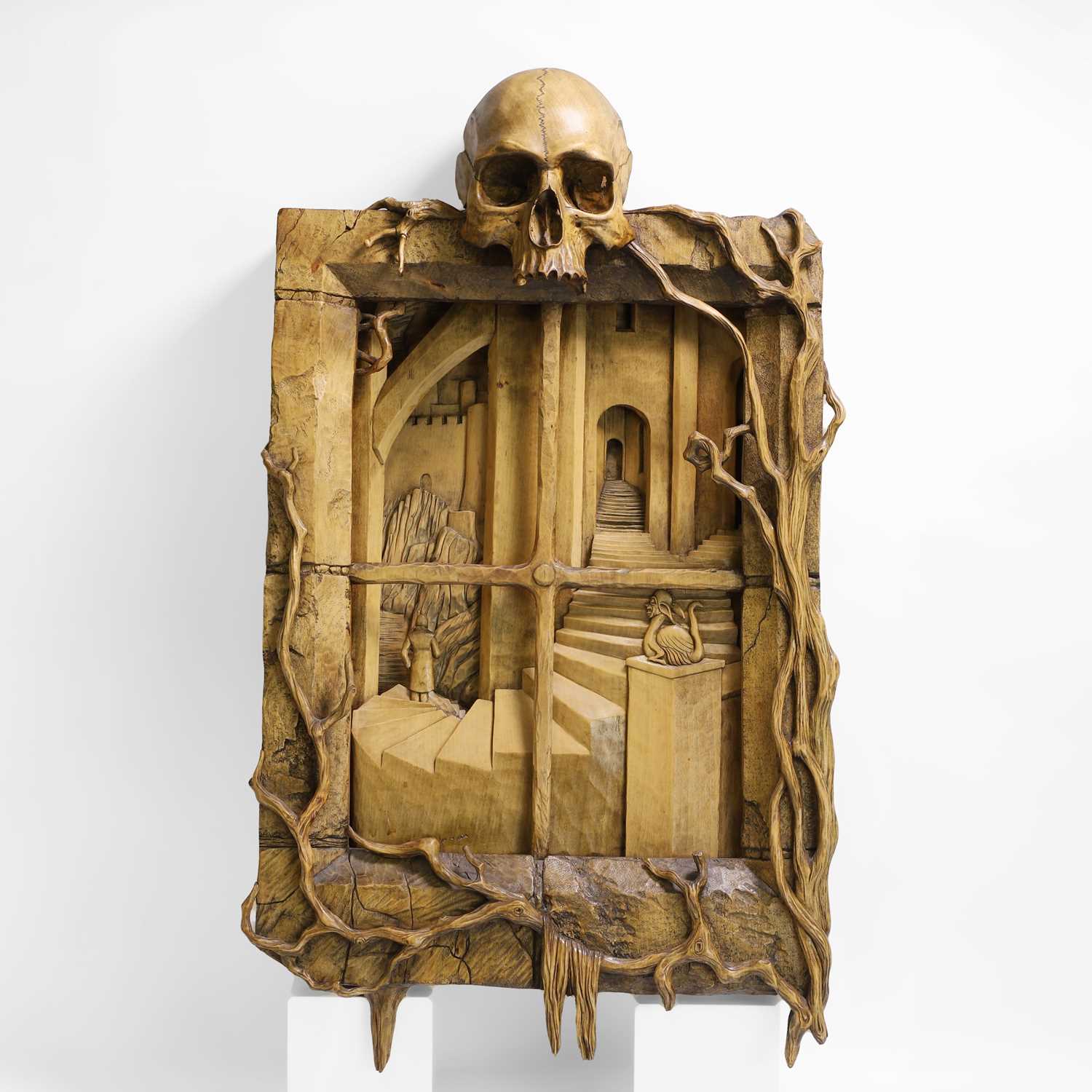 Lot 24 - A carved 'window' surmounted with a skull