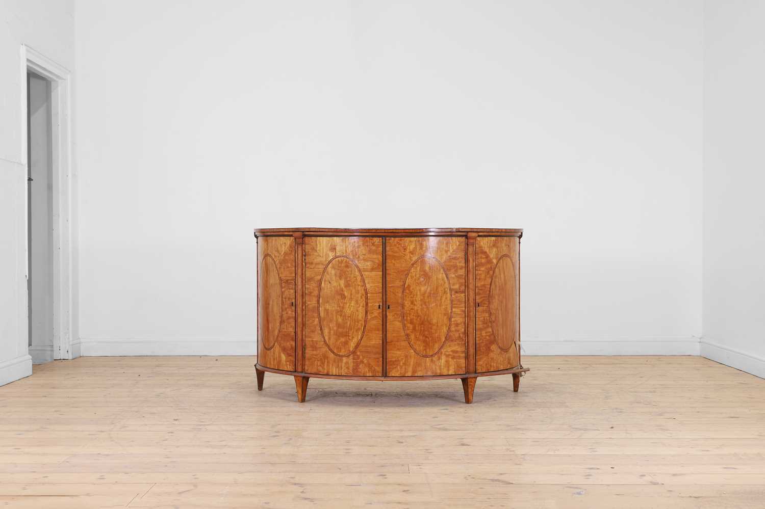 Lot 435 - A George III Sheraton period satinwood and tulipwood demilune side cabinet