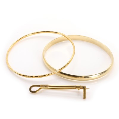 Lot 326 - Two gold bangles and a brooch