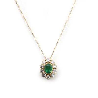 Lot 147 - An oval cut emerald and diamond cluster pendant and chain