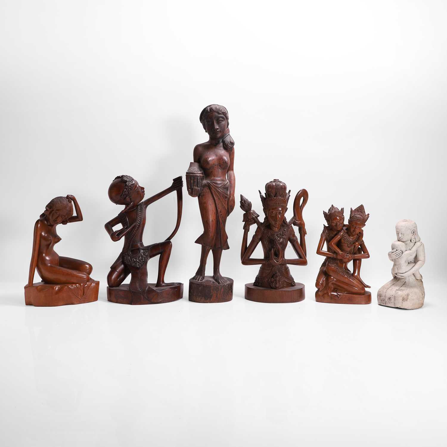 Lot 387 - A group of carved wood figures