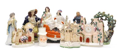 Lot 148 - A collection of Staffordshire pottery figures