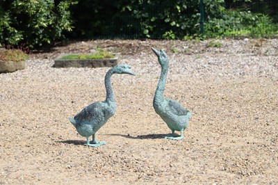 Lot 592 - A pair of patinated bronze garden statues