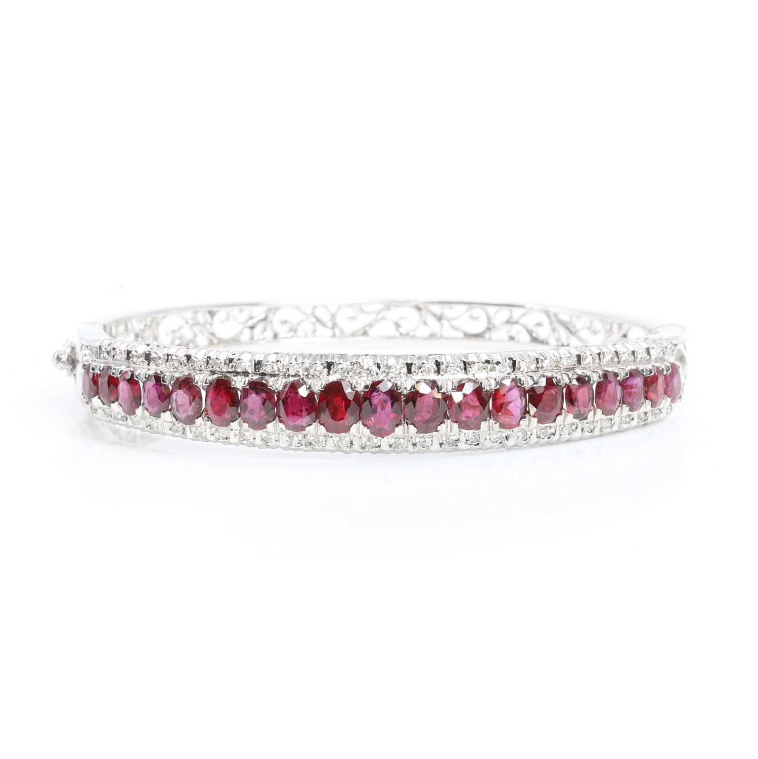 Lot 126 - A ruby and diamond hinged bangle,