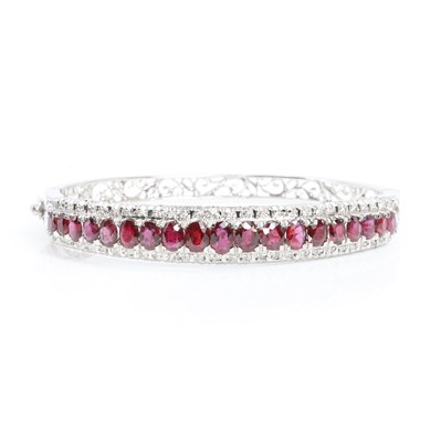 Lot 185 - A ruby and diamond hinged bangle