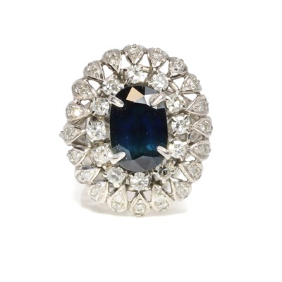 Lot 211 - A sapphire and diamond bombé cluster ring