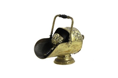 Lot 460 - An Arts & Crafts brass coal scuttle and shovel