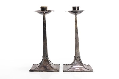Lot 165 - A pair of Arts and Crafts silver candlesticks