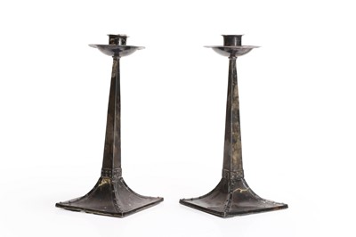 Lot 165 - A pair of Arts and Crafts silver candlesticks