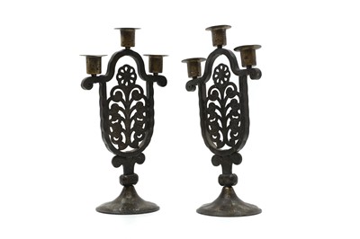 Lot 243 - A pair of patinated iron and steel Arts and Crafts candlesticks