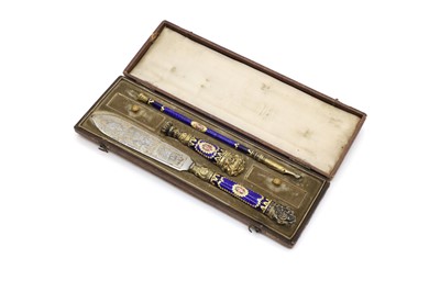 Lot 374 - A cased gilt metal and enamelled desk set