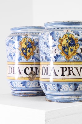 Lot 218 - A near pair of armorial maiolica albarellos