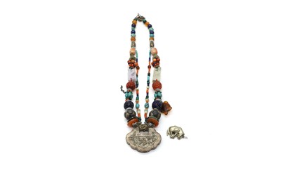 Lot 238 - A carved agate, lapis, malachite and silver amulet necklace